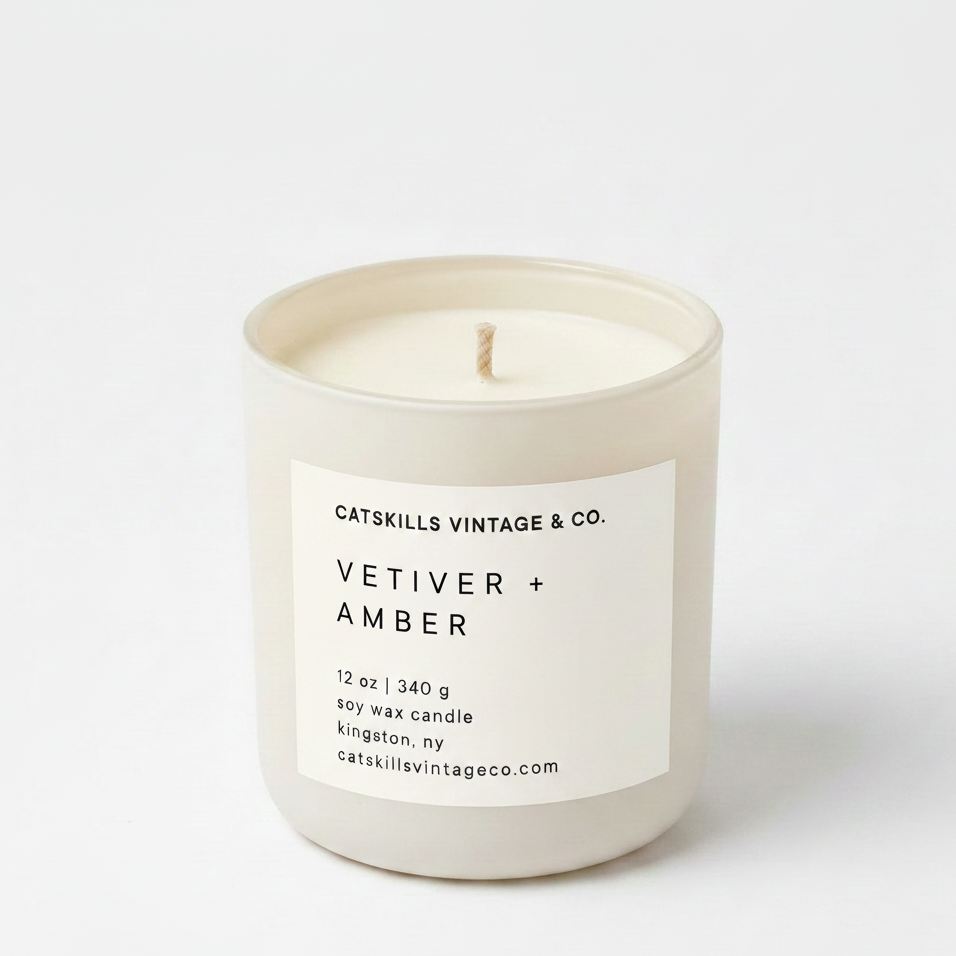 Vetiver + Amber 12 oz soy candle in cream matte glass jar