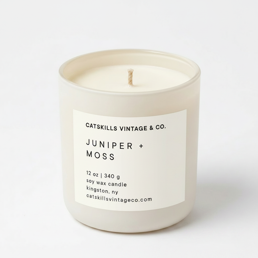 Juniper + Moss 12 oz soy candle in cream matte glass jar
