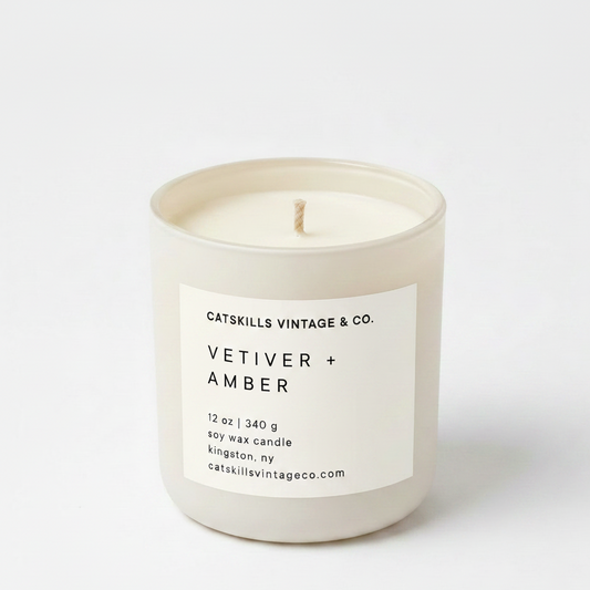 Vetiver + Amber 12 oz soy candle in cream matte glass jar